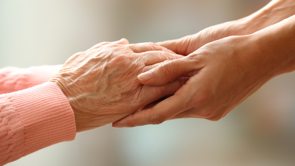 old and young people holding hands