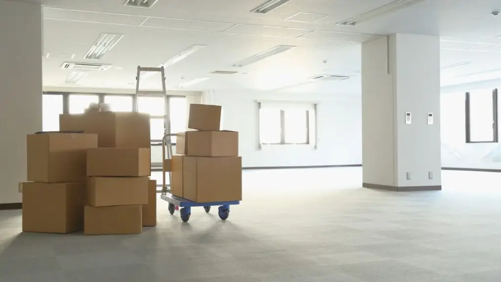 Boxes stacked on a cart in an empty office
