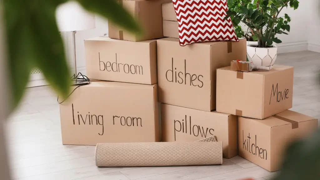 Moving boxes in a home labeled for each room