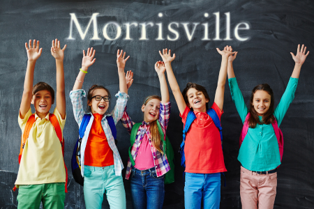 Children standing in front of a chalk board in a Morrisville classroom